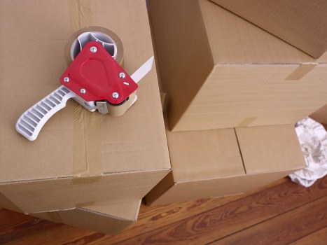 Movers carrying boxes during a flat move in New Addington